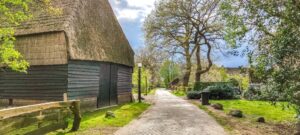 old barn along a cobbled street in Oud Aalden part of a 3-day itinerary in Drenthe