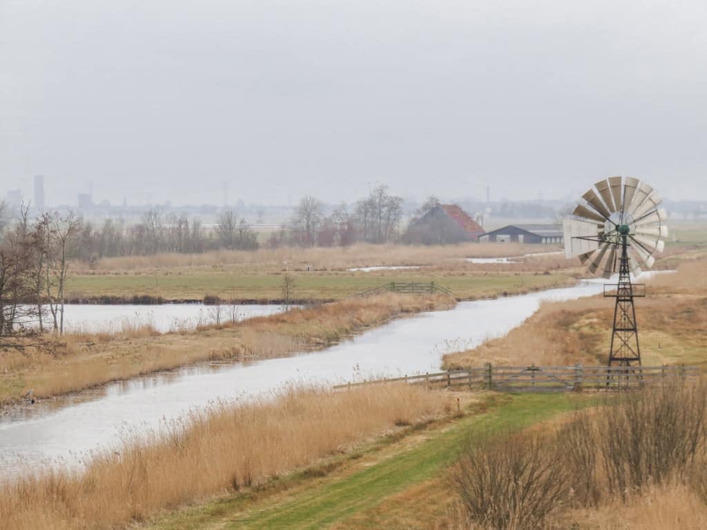 a criss-cross of water canals and an American type of wind generator at De Alde Feanen