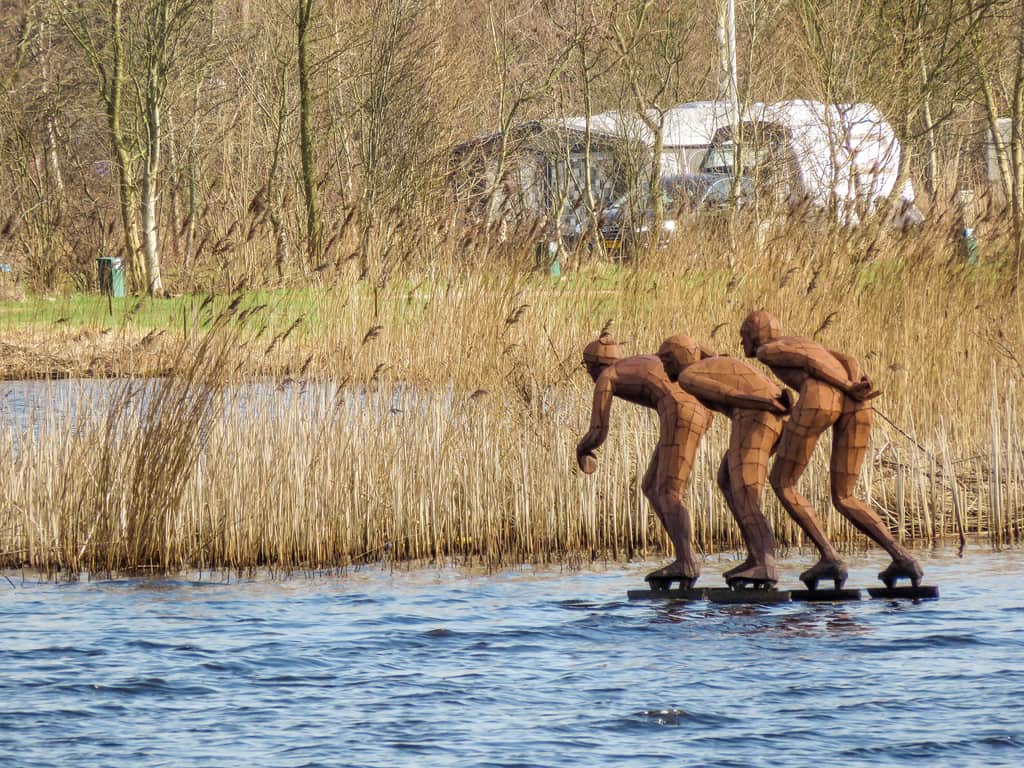 a monument on water of three ice skaters in Earnewald