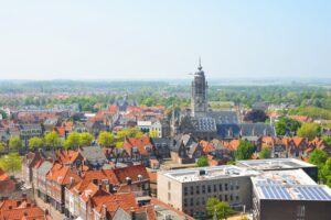 a cityscape with a church and a church tower in the middle; Things to do in Middelburg