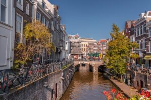 a canal lined up with houses in the Dutch city of Utrecht depicting where to stay in Utrecht, the Netherlands