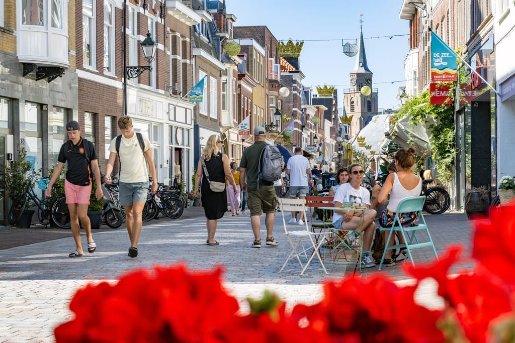 a busy street in Scheveningen with a church a the end, Keizerstraat - one of the best things to do in Scheveningen